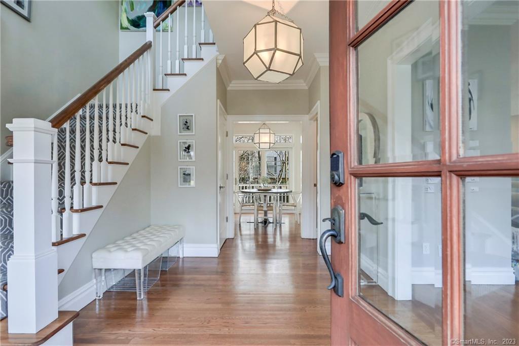 a view of entryway and hall with wooden floor