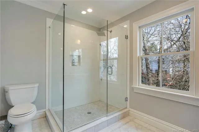 a bathroom with a glass shower door