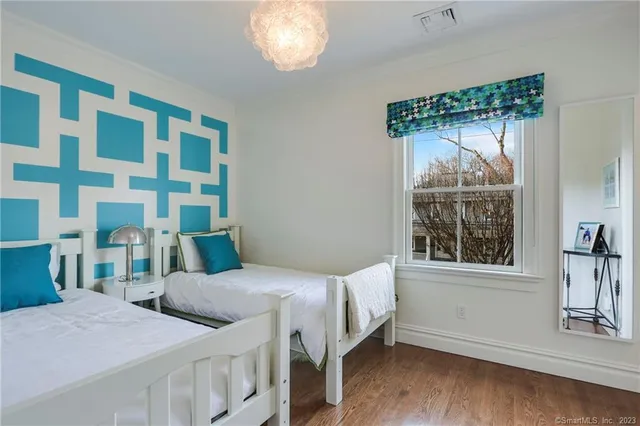 a bedroom with a bed and a window