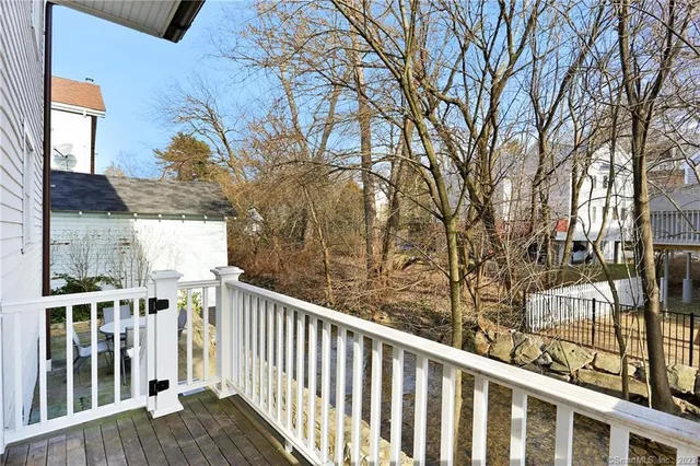 a view of a balcony with wooden fence and floor