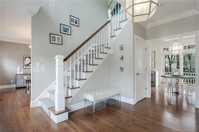 a view of entryway and hall with wooden floor