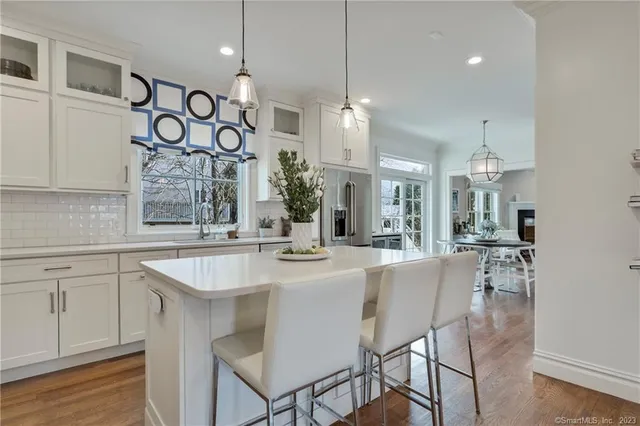 a large kitchen with a table and chairs