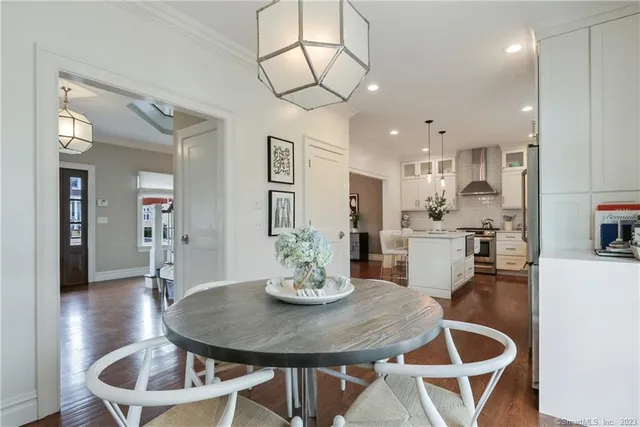 a dining room with furniture and wooden floor