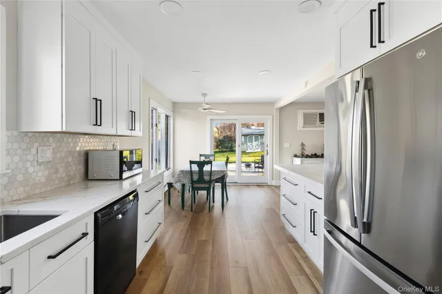 a kitchen with white cabinets and stainless steel appliances