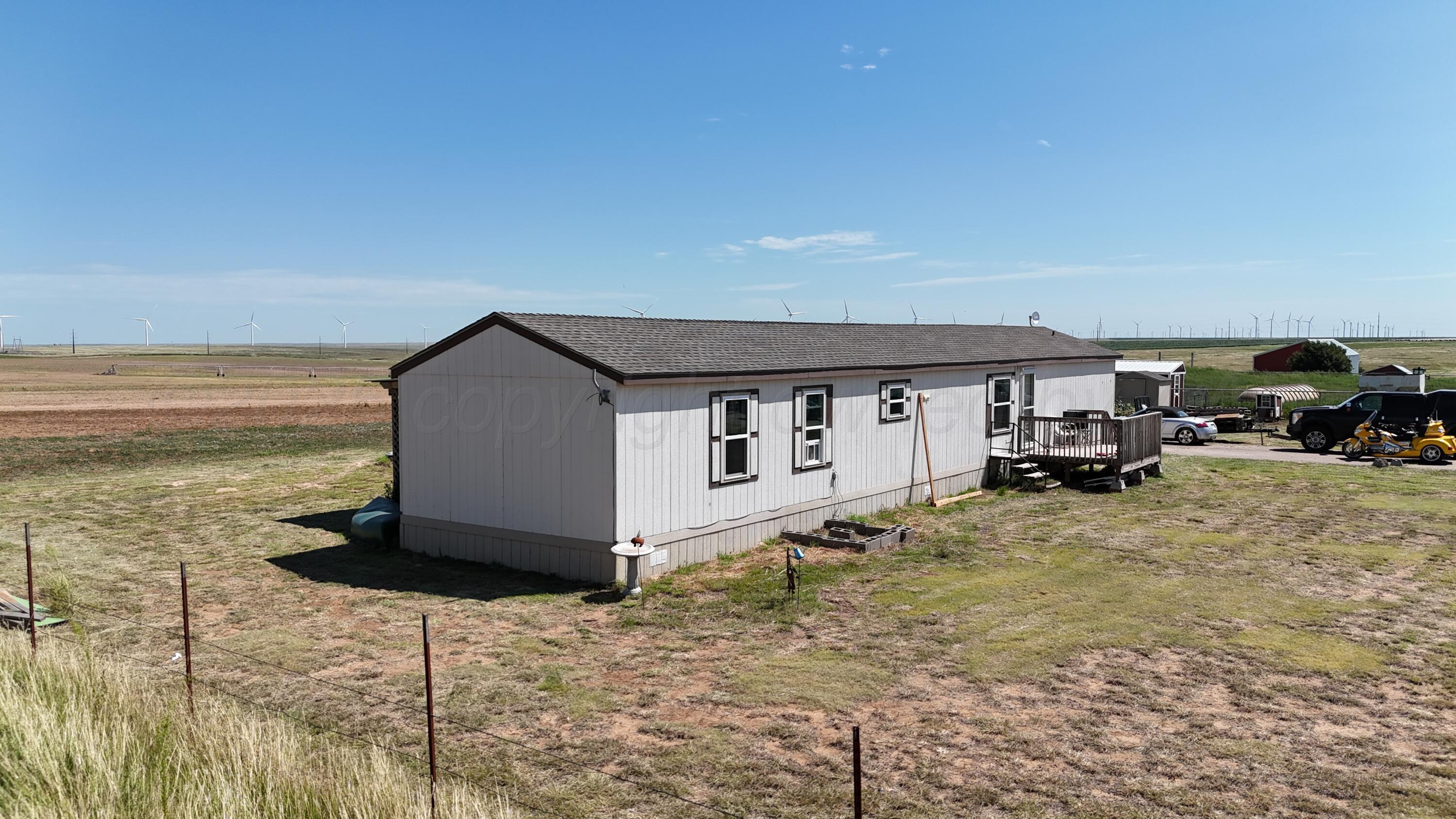1405 County Road 17 Panhandle, TX 79068 - Photo 1 of 14 a view of a house with backyard and sitting area