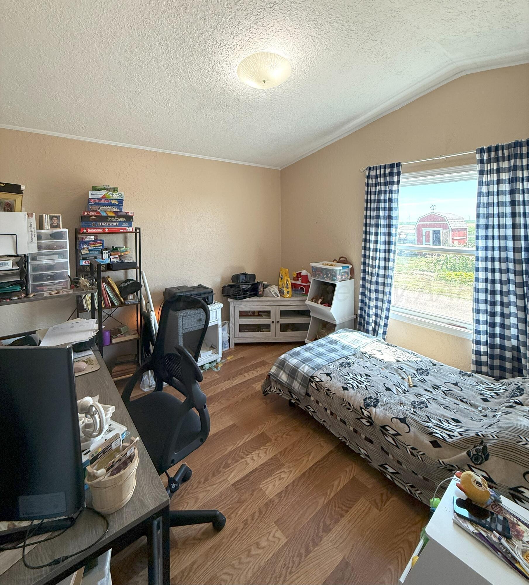 1405 County Road 17 Panhandle, TX 79068 - Photo 11 of 14 a bedroom with furniture and a wooden floor