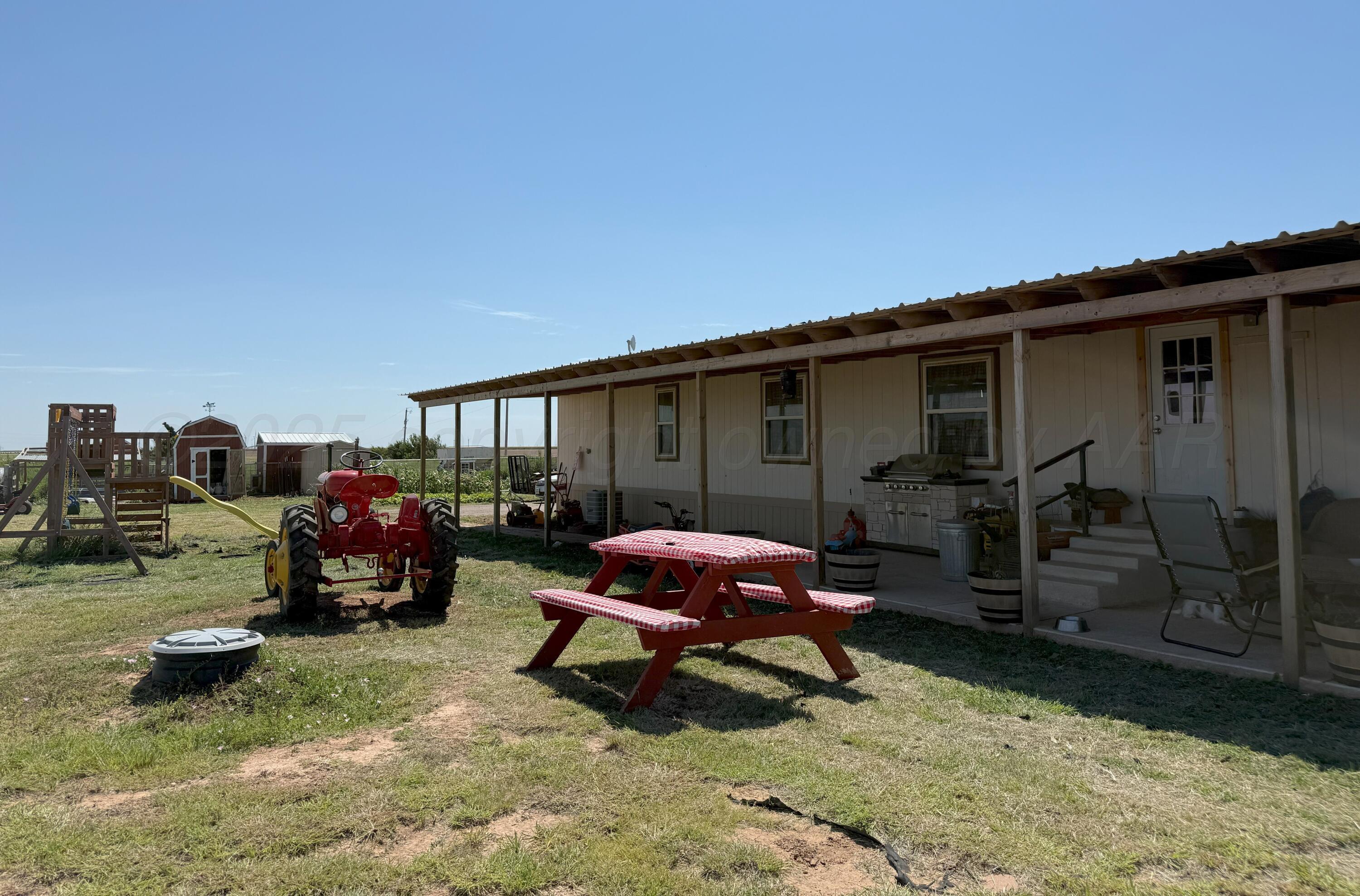 1405 County Road 17 Panhandle, TX 79068 - Photo 4 of 14 a view of a house with backyard and porch