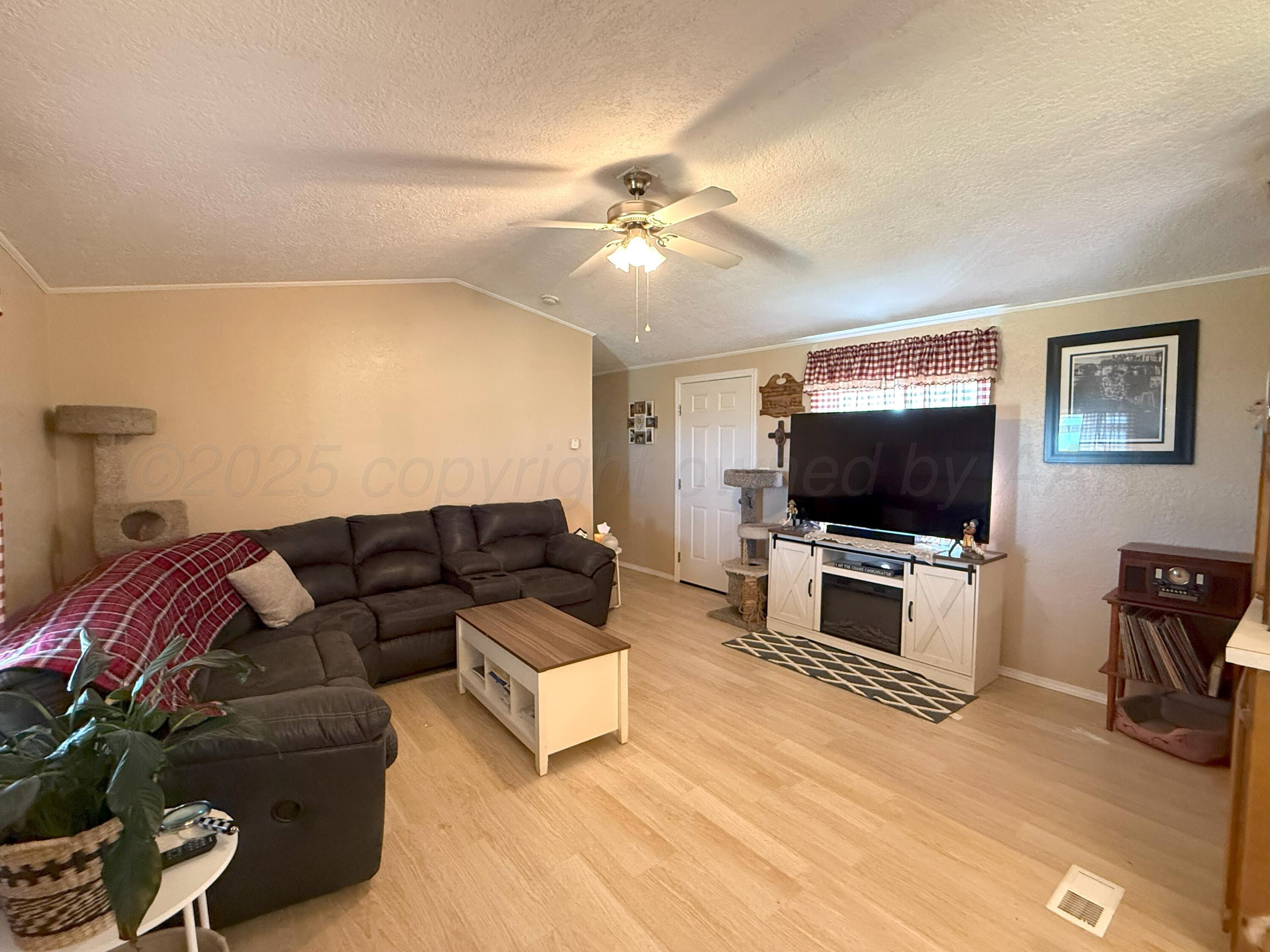 1405 County Road 17 Panhandle, TX 79068 - Photo 5 of 14 a living room with furniture and a flat screen tv