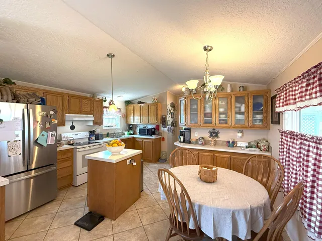 a large kitchen with a table and chairs