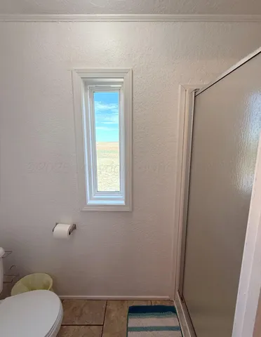 a bathroom with a toilet and a shower