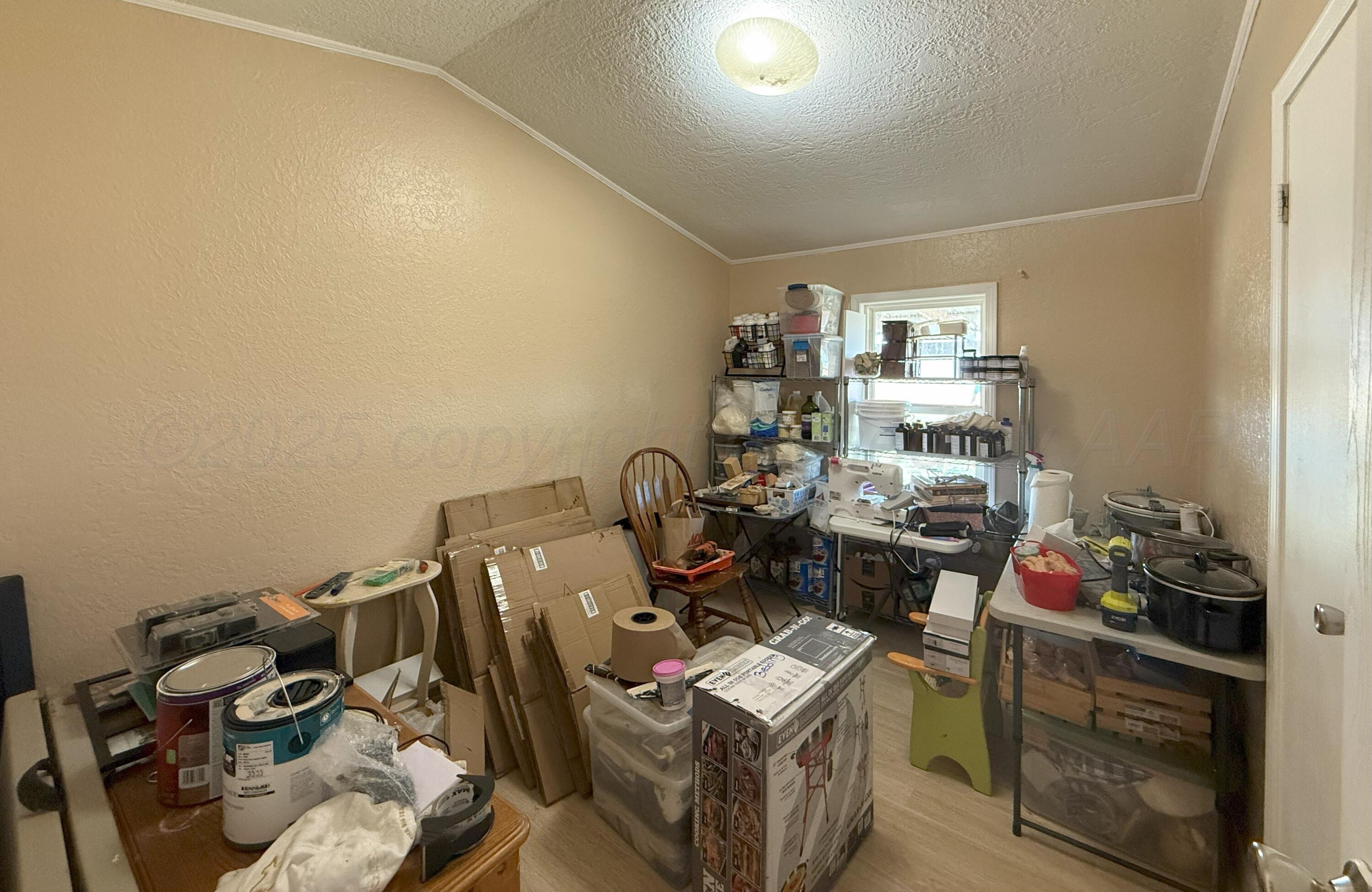 1405 County Road 17 Panhandle, TX 79068 - Photo 10 of 14 a view of a workspace with furniture and clutter