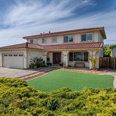 a view of a house with a yard and plants