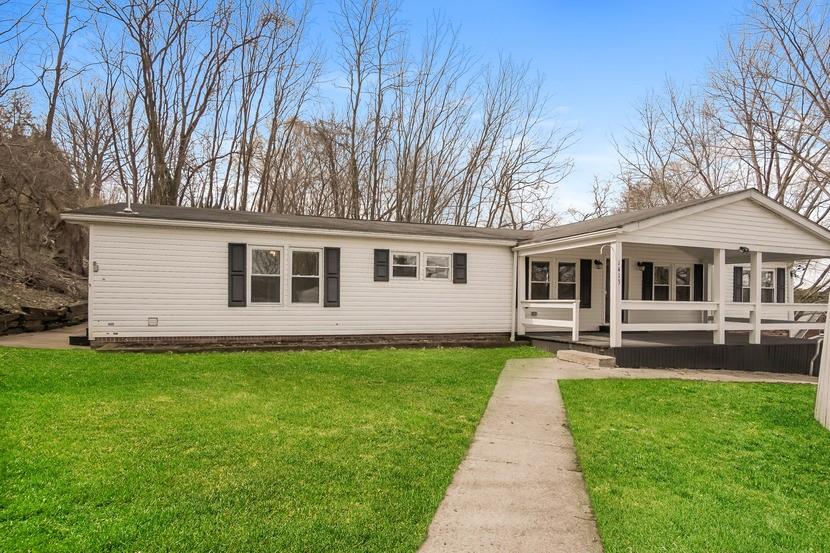 1413 Wimpole Street Aliquippa, PA 15001 - Photo 1 of 15 a front view of a house with a garden and patio