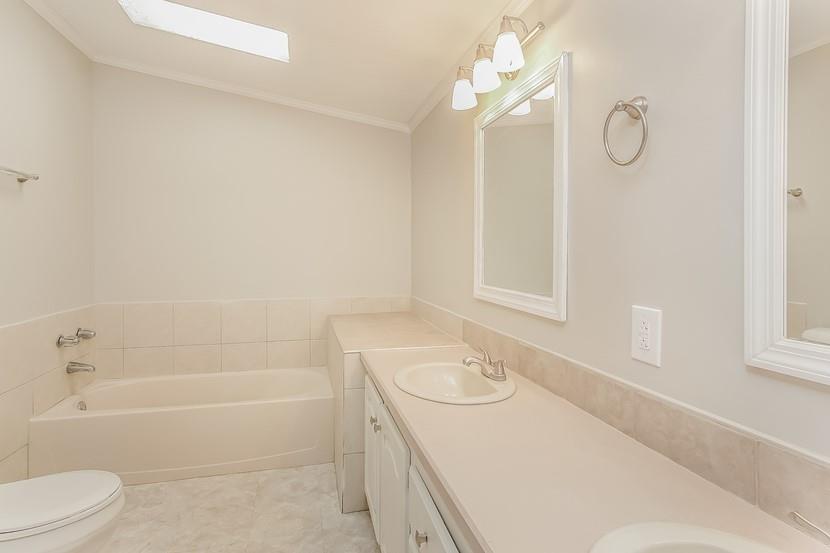 1413 Wimpole Street Aliquippa, PA 15001 - Photo 12 of 15 a bathroom with a granite countertop sink a toilet and shower