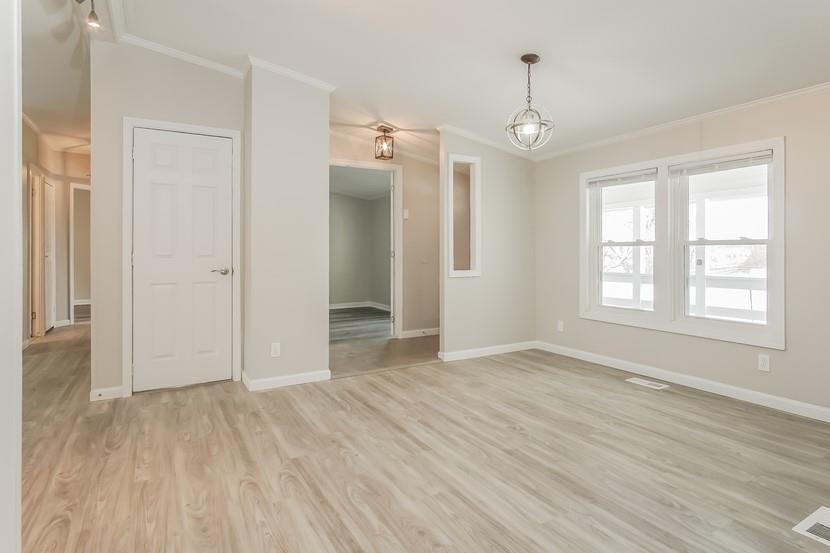1413 Wimpole Street Aliquippa, PA 15001 - Photo 5 of 15 an empty room with wooden floor and windows