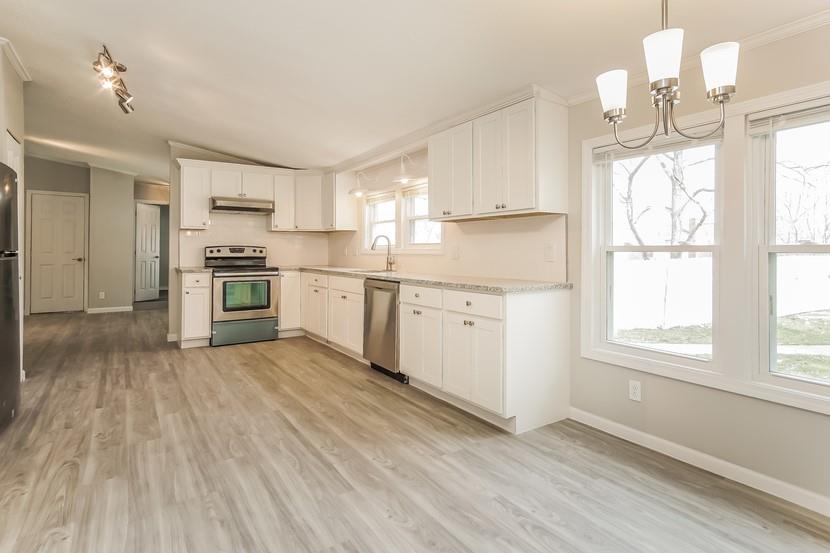 1413 Wimpole Street Aliquippa, PA 15001 - Photo 6 of 15 a kitchen with a stove a sink and white cabinets