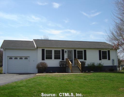 a view of house with yard and front view of a house