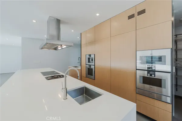 a kitchen with stainless steel appliances a sink and a large window