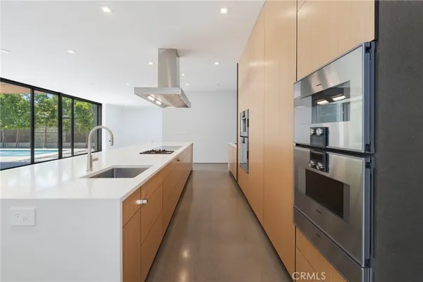 a view of a kitchen with furniture and natural light
