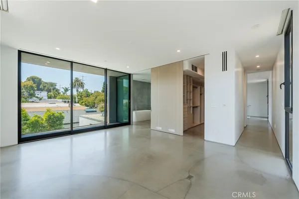 an empty room with windows and closet