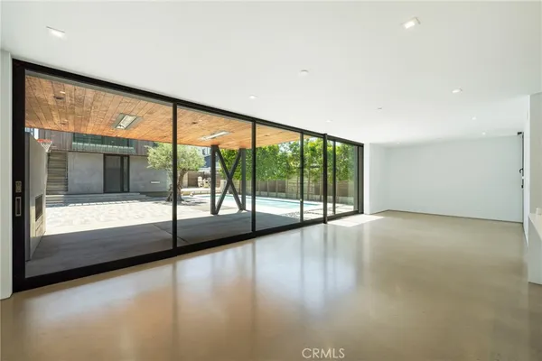 a large white kitchen with a large window