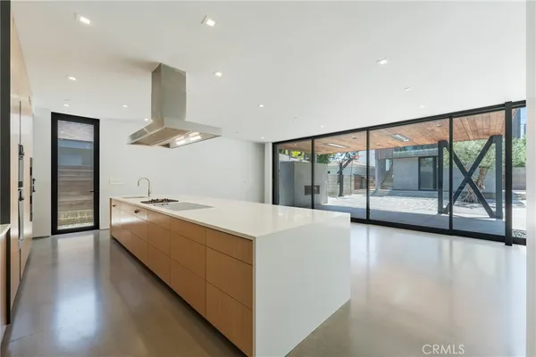 a large kitchen with stainless steel appliances a large counter top