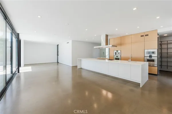 a large kitchen with a large window and stainless steel appliances