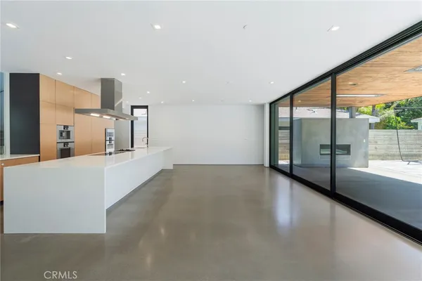 a large kitchen with a large window and stainless steel appliances