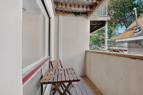 a view of balcony with wooden floor