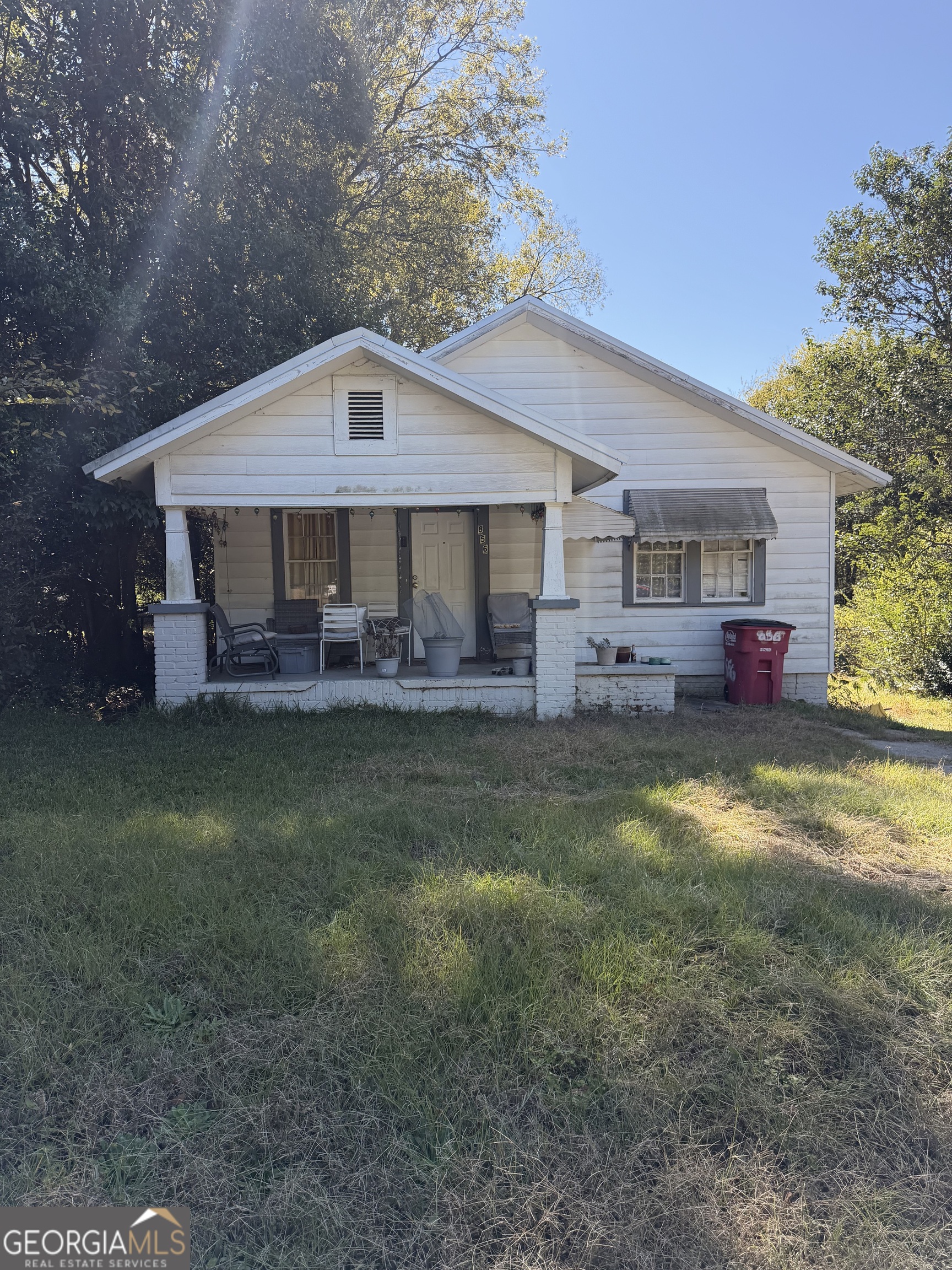 a front view of house with outdoor seating and yard