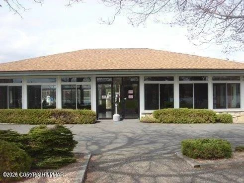 front view of a brick house with a yard