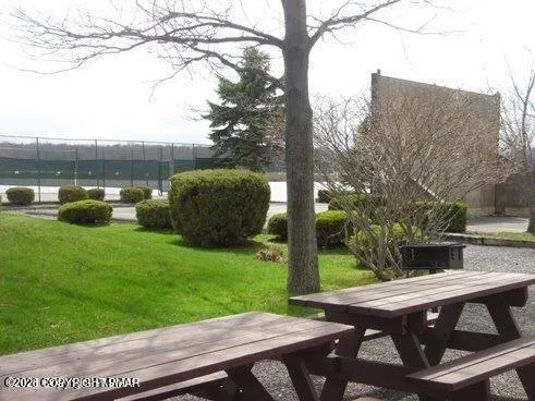 a view of backyard with seating area and green space