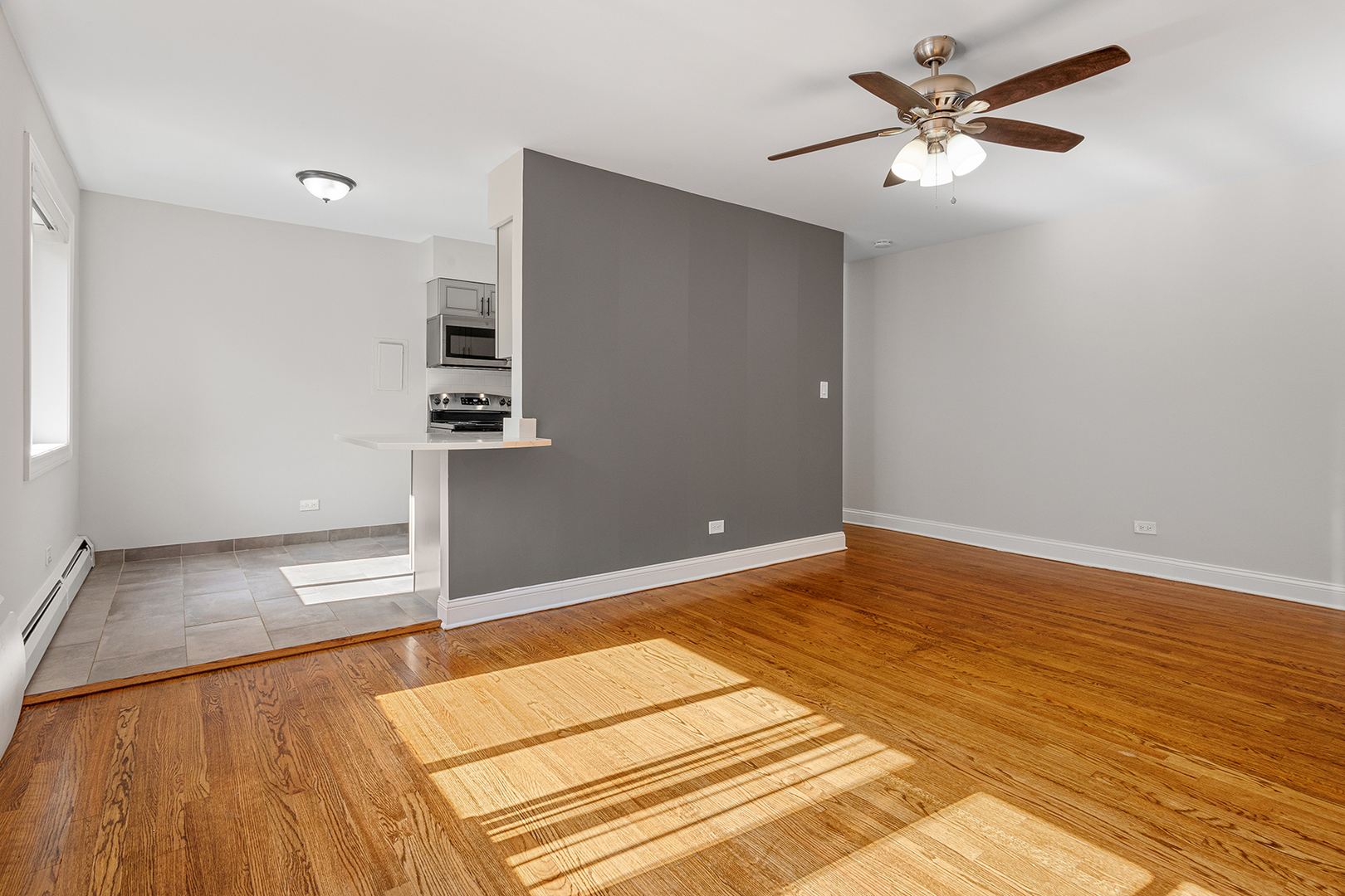 6826 North Ridge Boulevard, Unit 201 Chicago, IL 60645 - Photo 4 of 13 a view of a room with wooden floor and a ceiling fan