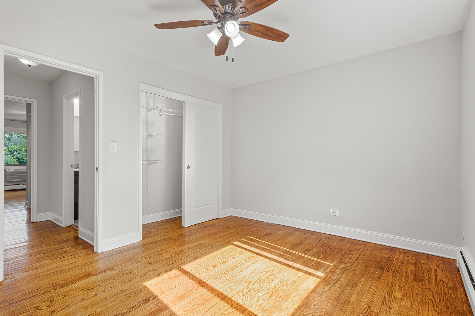 6826 North Ridge Boulevard, Unit 201 Chicago, IL 60645 - Photo 10 of 13 wooden floor in an empty room with a window