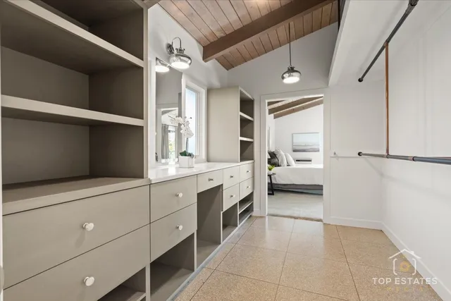a spacious en suite bathroom with a toilet a sink and mirror