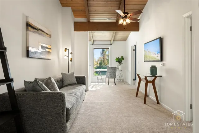 a living room with furniture a chandelier and a window
