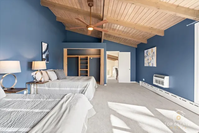 a large bed sitting in a bedroom next to a window