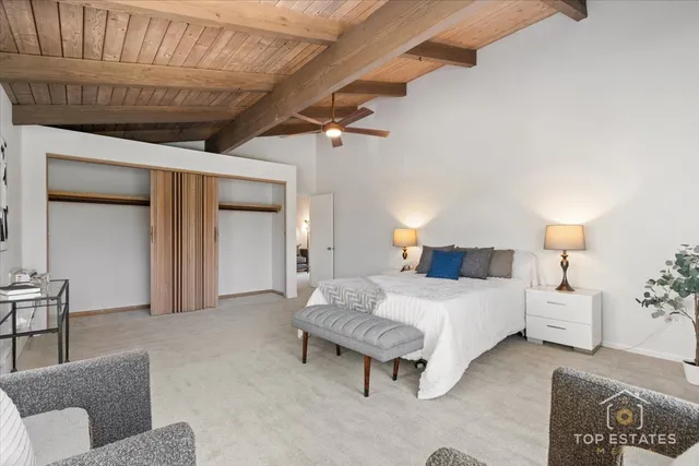 a spacious bedroom with a bed and a couch