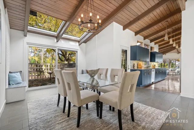 a dining room with furniture a chandelier and wooden floor