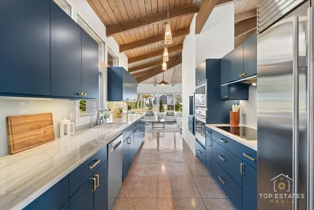 a kitchen with stainless steel appliances granite countertop a refrigerator a sink and dishwasher