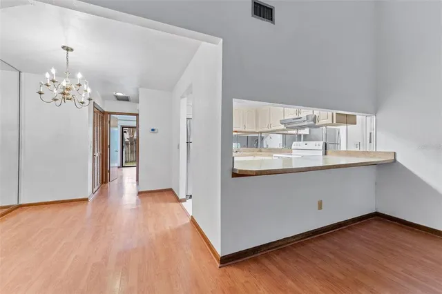 a view of a room with wooden floor and cabinet