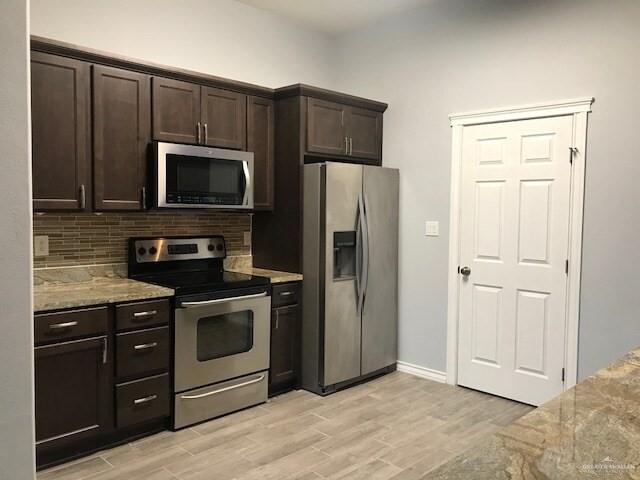 412 Quail Avenue McAllen, TX 78504 - Photo 2 of 7 a kitchen with a stove microwave and refrigerator