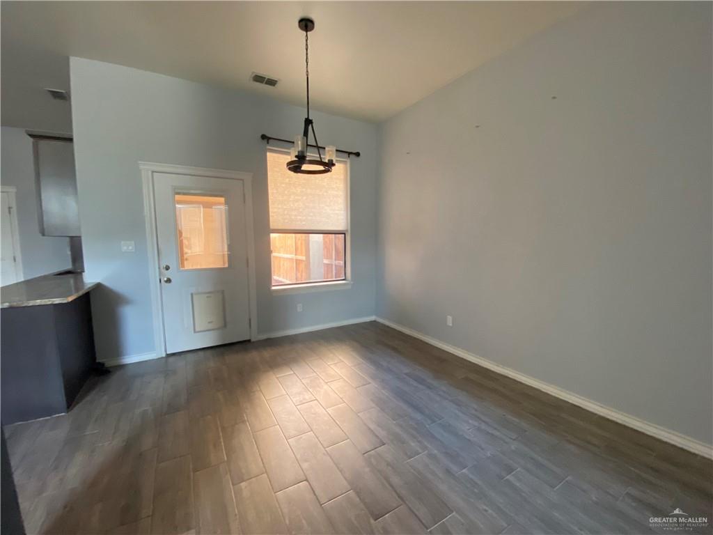 412 Quail Avenue McAllen, TX 78504 - Photo 4 of 7 a view of empty room with wooden floor and fan