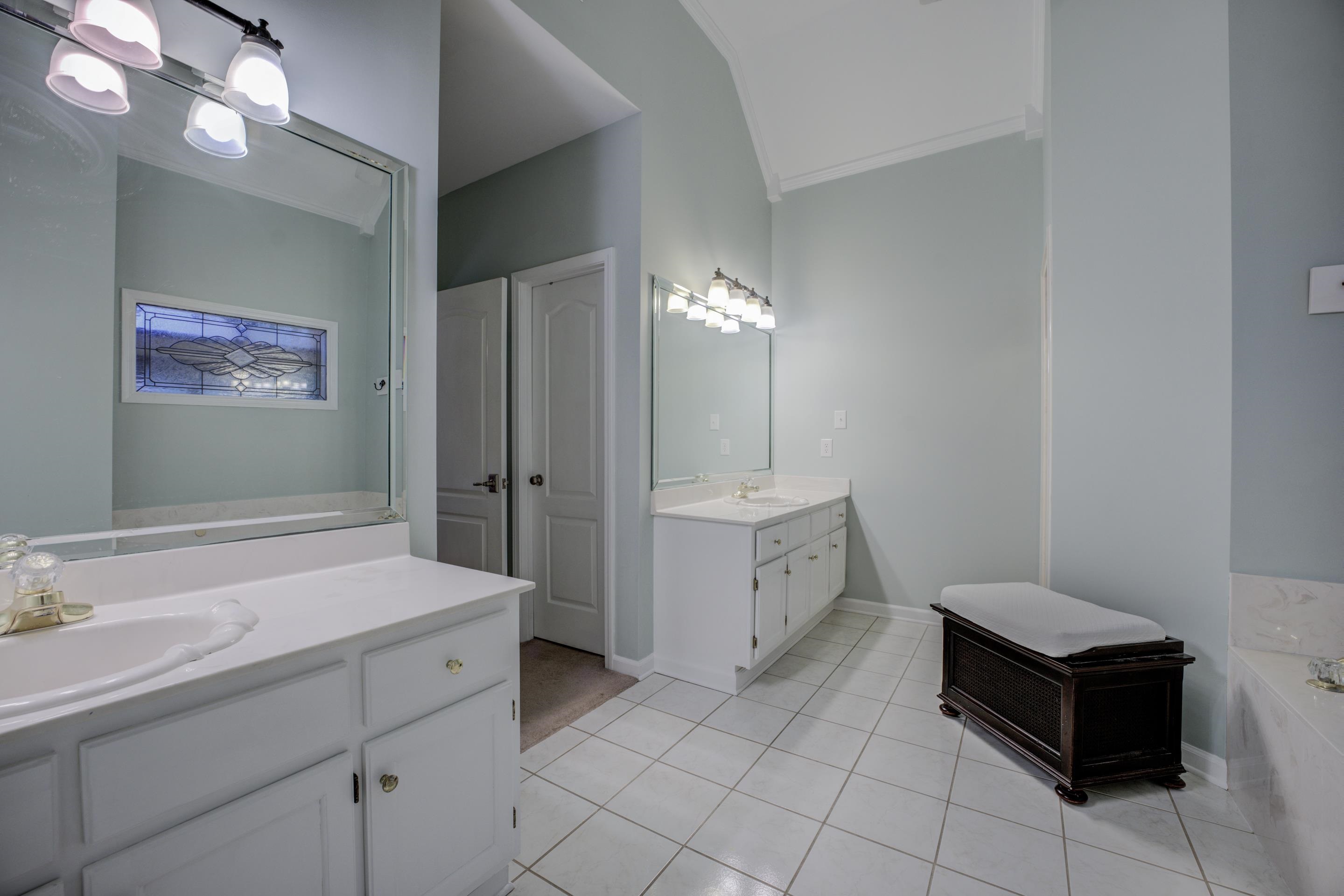 1594 John Ridge Drive Collierville, TN 38017 - Photo 14 of 29 Bathroom featuring tile patterned floors, crown molding, vanity, and a relaxing tiled tub