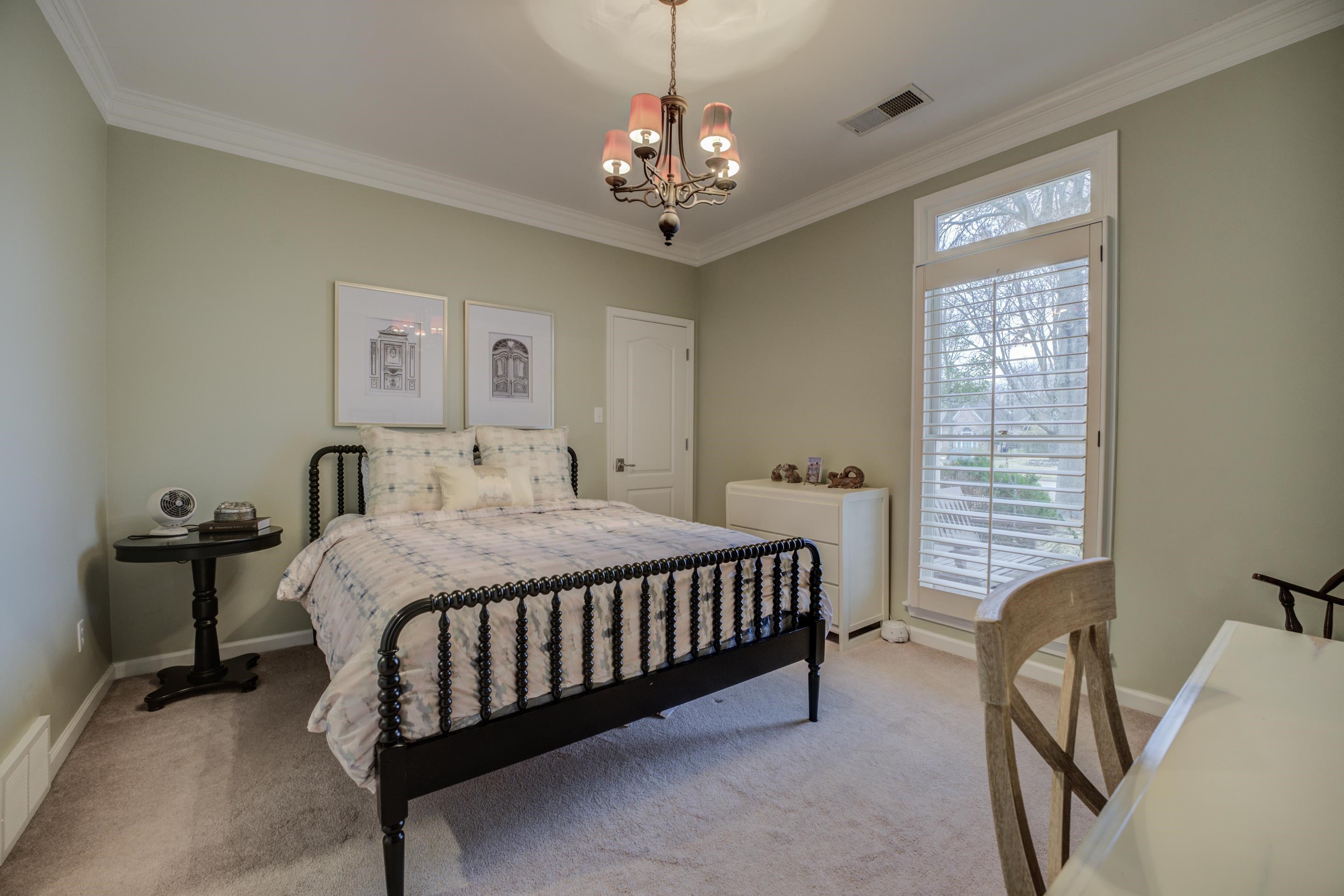 1594 John Ridge Drive Collierville, TN 38017 - Photo 16 of 29 Carpeted bedroom with an inviting chandelier, multiple windows, and crown molding
