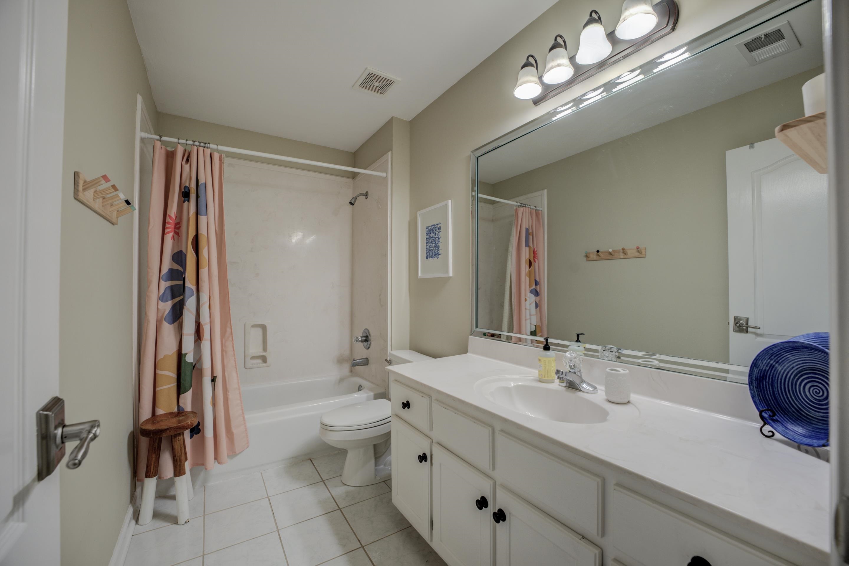 1594 John Ridge Drive Collierville, TN 38017 - Photo 19 of 29 Full bathroom featuring tile patterned flooring, vanity, toilet, and shower / tub combo with curtain