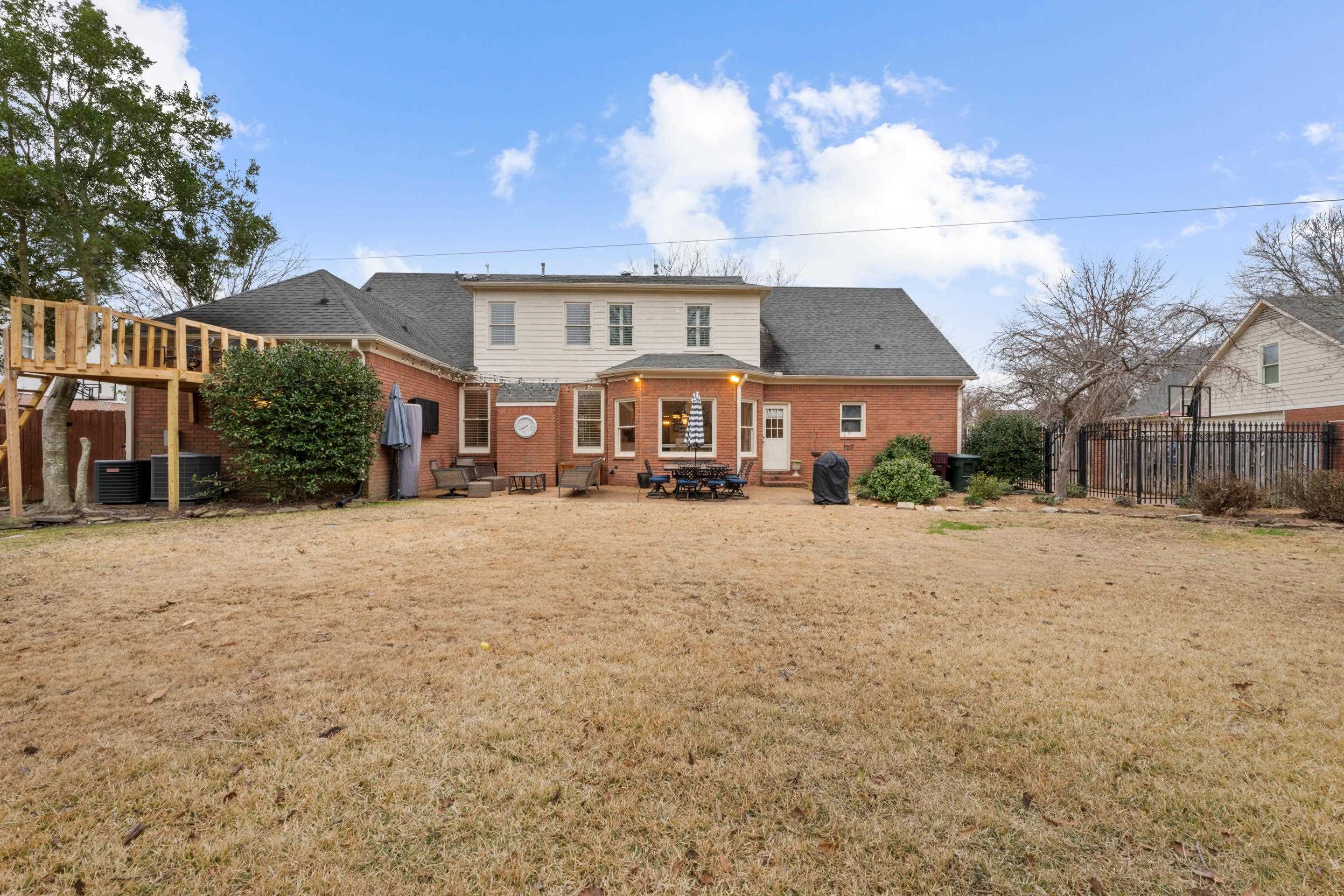 1594 John Ridge Drive Collierville, TN 38017 - Photo 25 of 29 Back of property with central air condition unit, a yard, and a wooden deck