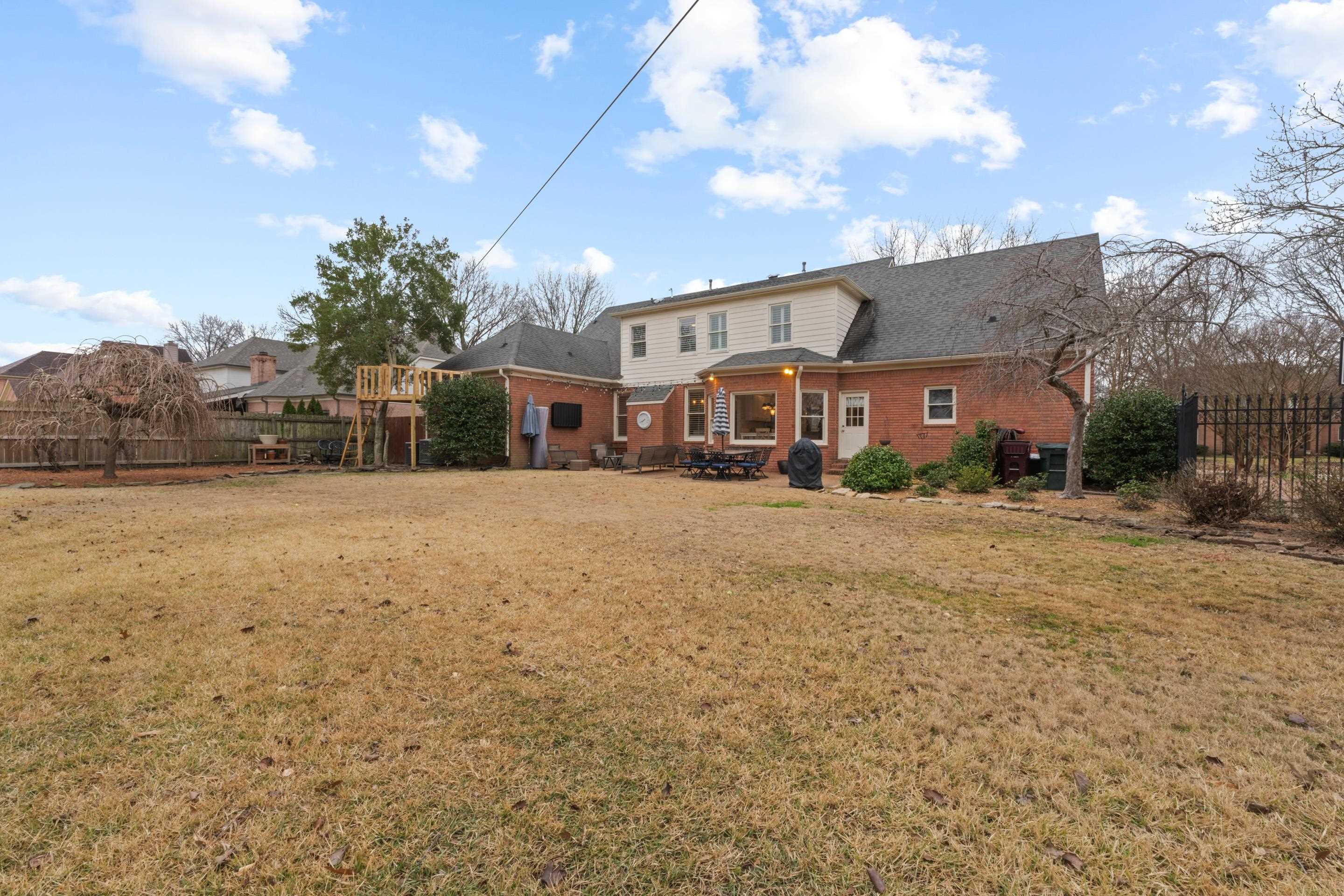 1594 John Ridge Drive Collierville, TN 38017 - Photo 26 of 29 Rear view of house with a lawn