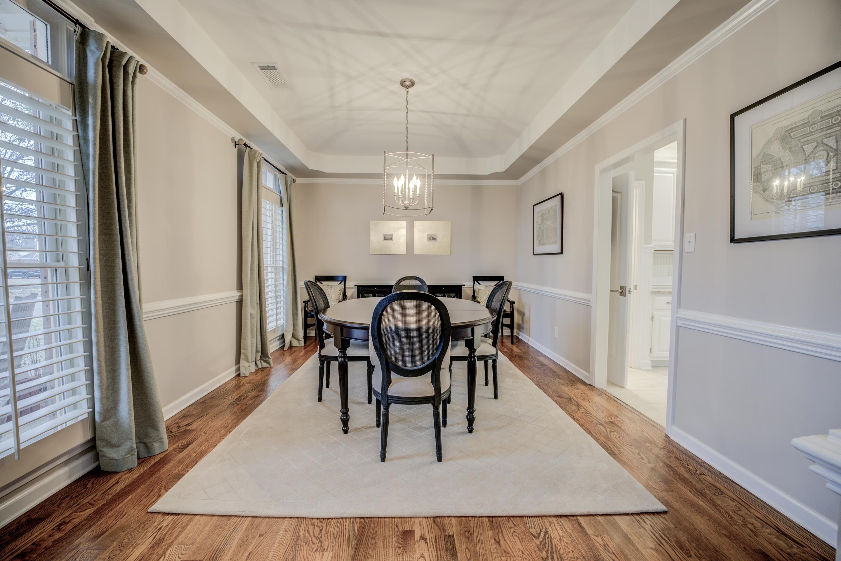1594 John Ridge Drive Collierville, TN 38017 - Photo 5 of 29 Dining space featuring a chandelier, wood-type flooring, a raised ceiling, and ornamental molding