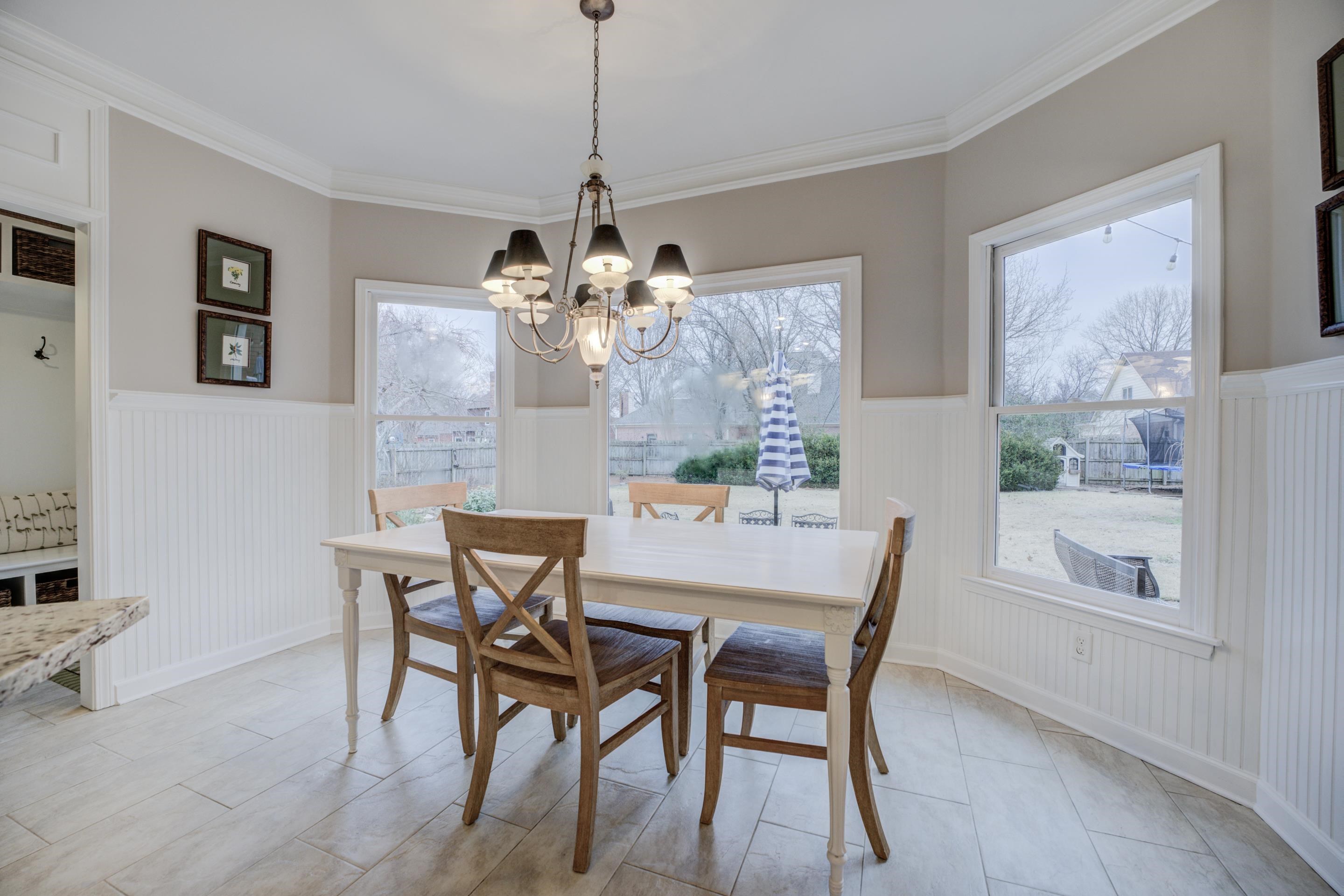 1594 John Ridge Drive Collierville, TN 38017 - Photo 9 of 29 Dining space with crown molding, light tile patterned floors, and an inviting chandelier
